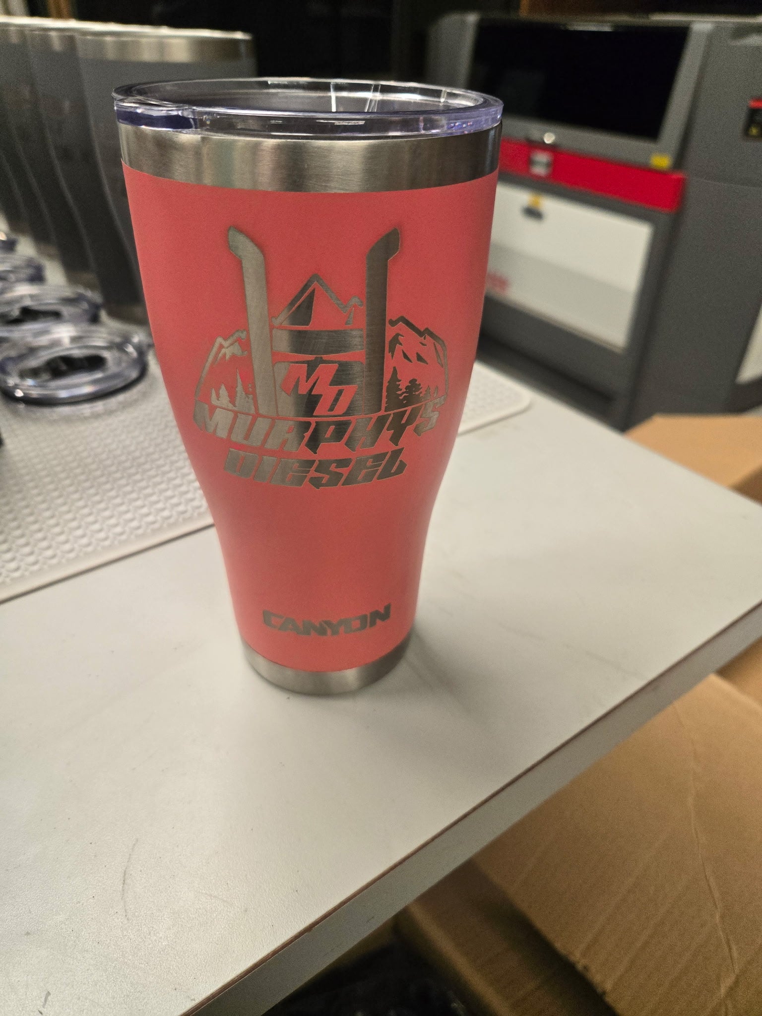 It's About To Get Western 30oz Tumbler, close-up of the mountain logo on the reverse side